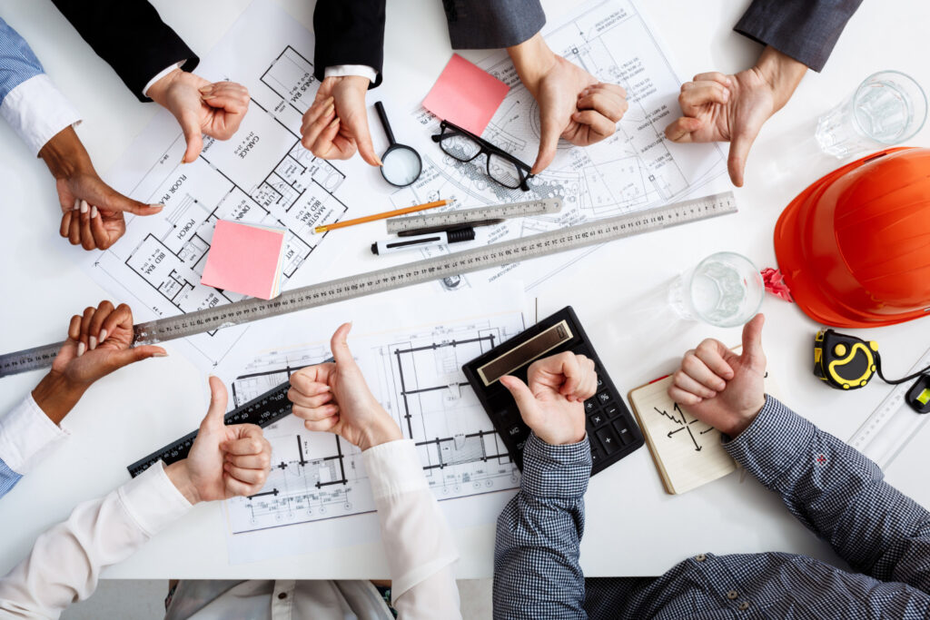 businessmen-hands-white-table-with-documents-drafts