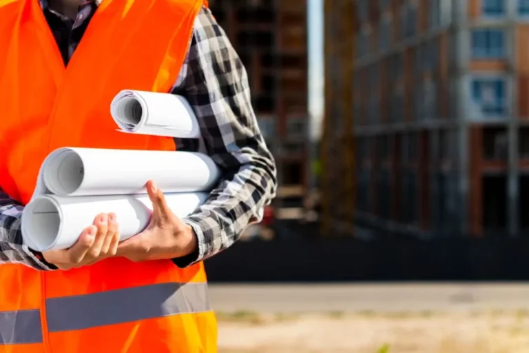 close-up-construction-engineer-holding-plans-hands