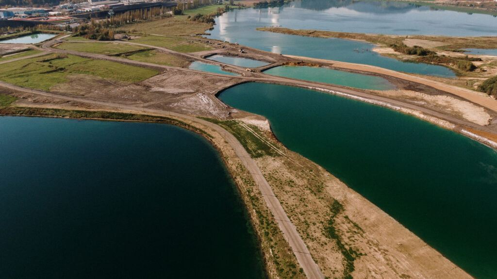 aerial-shot-landscape-surrounded-by-mountains-lakes-with-industrial-disaster