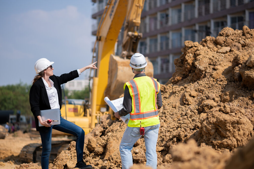 Construction manager and engineer going over construction documents at a construction site