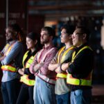 Employees of a public works agency stand together on a work site