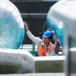 Engineers inspect completed water tanks at a treatment plant