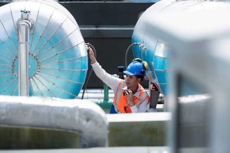 Engineers inspect completed water tanks at a treatment plant