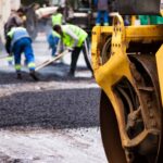 Road construction crew using heavy machinery
