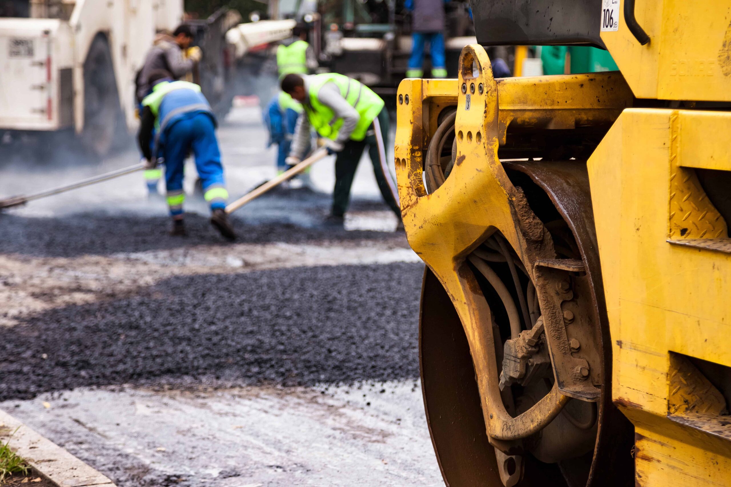 Road construction crew using heavy machinery