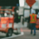 Blurry photo of a construction worker walking in a construction site
