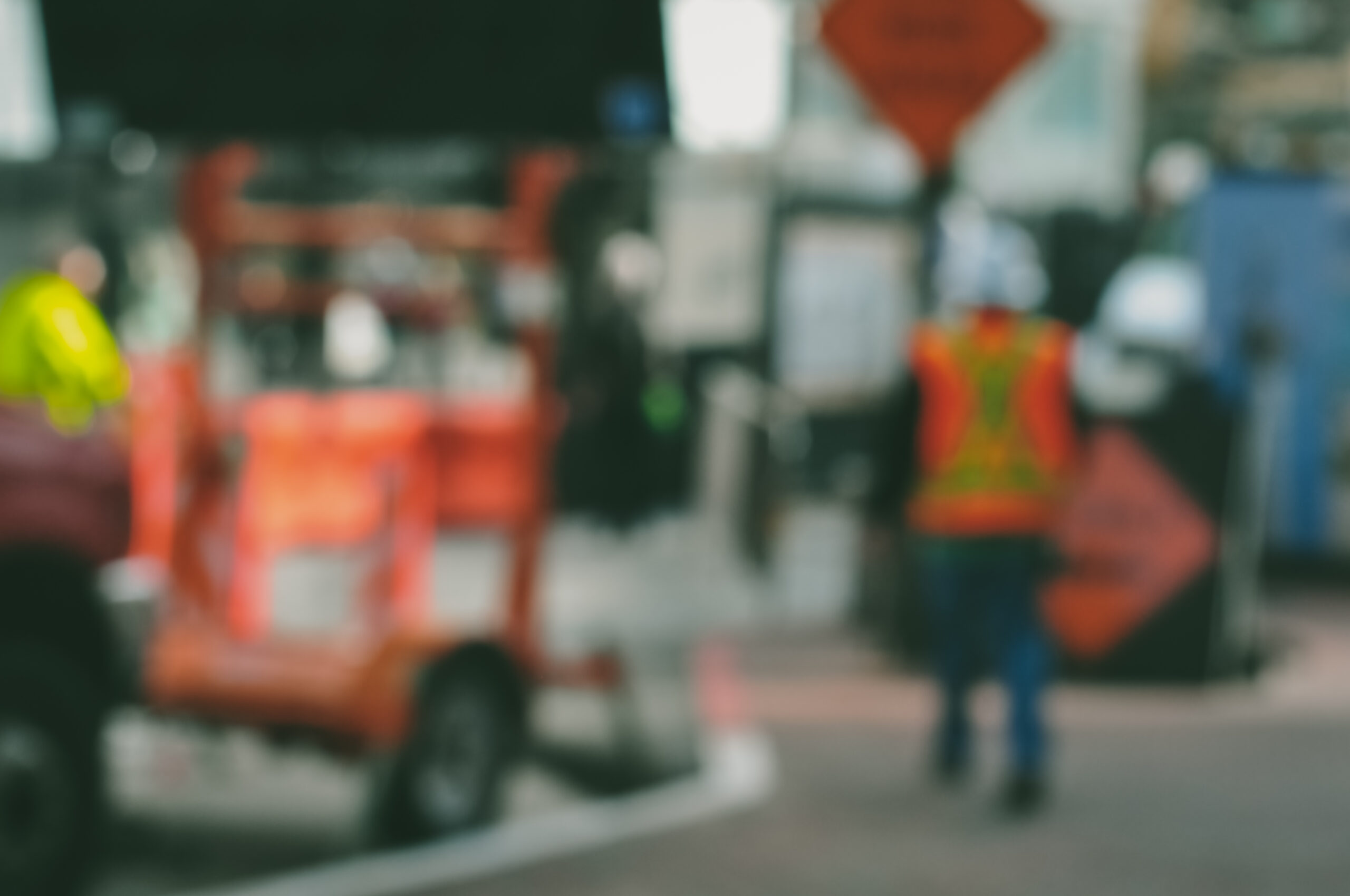 Blurry photo of a construction worker walking in a construction site